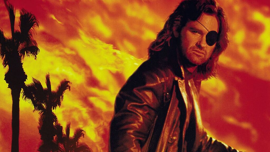 Kurt Russell as Snake Plissken (Movie) - Snake Plissken on a classic 90's movie poster (Escape from Los Angeles). The character is in the middle of an environment on fire, referring to the post-apocalyptic universe of the character's film franchise - Mortal Kombat 12?